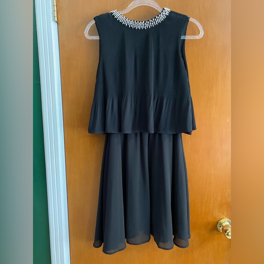 Black tiered dress with beading detail on neckline